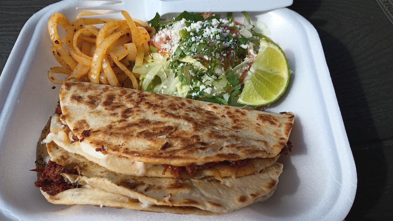 Crispy griddled chorizo quesadilla served with sautéed onions and a fresh queso-fresco salad