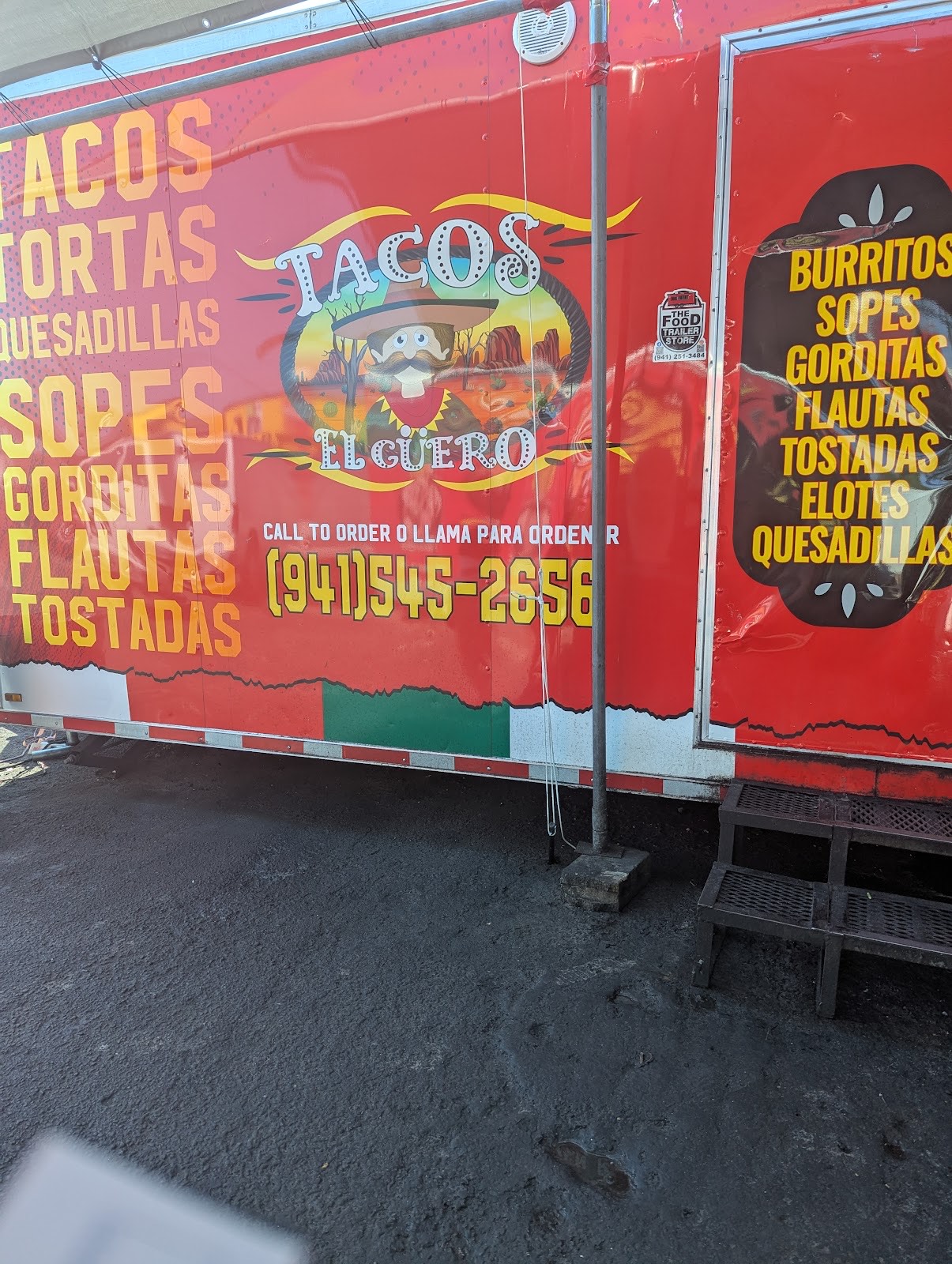 The red Tacos El Güero food truck painted with its full menu — tacos, tortas, quesadillas, sopes, gorditas, flautas — and the order line (941) 545-2656